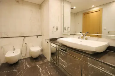 a bathroom with a sink and a toilet at Livbnb Suites - 1BR with Sea View & Beach Access in Dubai