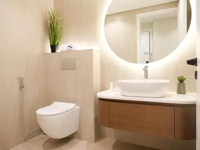 a bathroom with a sink and a toilet and a mirror at Lovely 1 bedroom apartment at 5 Star Resort in Dubai