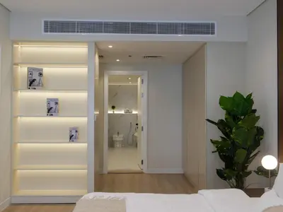 a room with a bed and a hallway with a bathroom at Lovely 1 bedroom apartment at 5 Star Resort in Dubai