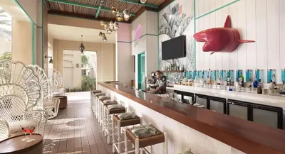 a restaurant with a bar with a fish on the wall at Fairmont The Palm Residences I Access to Hotel Facilities in Dubai