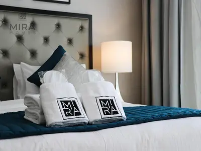 a hotel room with towels on a bed at Mira Holiday Homes - Newly serviced apartment in Dubai South in Dubai