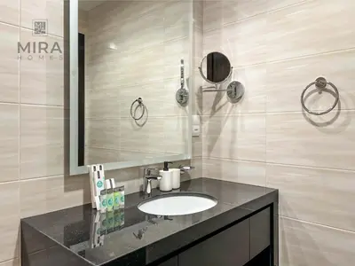 a bathroom with a sink and a mirror at Mira Holiday Homes - Newly serviced apartment in Dubai South in Dubai