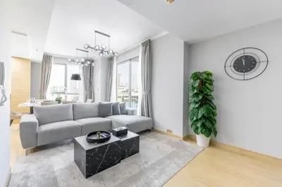 a living room with a couch and a table at Downtown Luxury I 5 Min Walk To Dubai Fountain! in Dubai