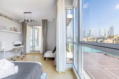 a bedroom with a bed and a large window at Downtown Luxury I 5 Min Walk To Dubai Fountain! in Dubai