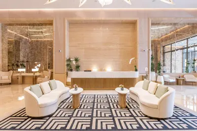 a lobby with two chairs and a reception desk at Ultra Luxury Palm Tower with Shared Hotel Facilities in Dubai