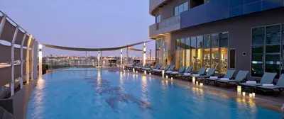 a large swimming pool on the side of a building at Damac Mall Street Residences in Dubai