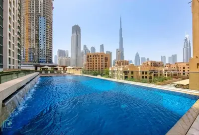 a large swimming pool with a city skyline in the background at High-End Designer Penthouse Full Burj Khalifa View in Dubai