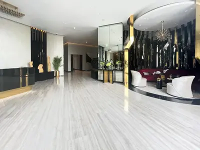 a bowling alley with white chairs in a room at Trophy Stays - Peaceful Golf side Escape Studio - Damac Hills in Dubai