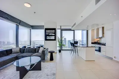 a living room with a couch and a table at Spacious 2 Bedroom in Marina Gate Jumeirah Living in Dubai