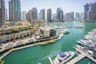 a group of boats docked at a marina in a city at Spacious 2 Bedroom in Marina Gate Jumeirah Living in Dubai