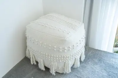 a white cake sitting on a floor next to a window at Tropical Loft with working station in JVC in Dubai