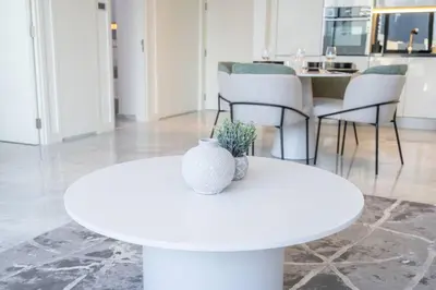 a white table with a vase on top of it at Cosmopolitan Apartment with Burj Khalifa View in Dubai