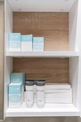 a shelf with two cups and boxes on it at Cozy studio in heart of Dubai - JVC in Dubai