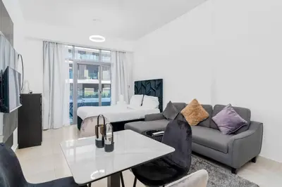 a living room with a couch and a table at Cozy studio in heart of Dubai - JVC in Dubai