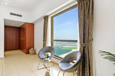 two chairs in a room with a large window at 2BR in JBR / Sea View / Dubai Marina / Walk2Beach in Dubai