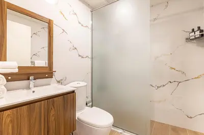 a bathroom with a toilet and a sink and a shower at Daniels 1BR Business Bay Partial Burj Khalifa View in Dubai