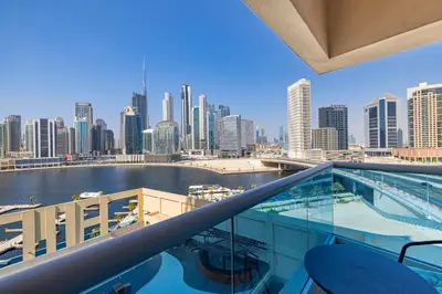 a view of a city from the balcony of a building at Daniels 1BR Business Bay Partial Burj Khalifa View in Dubai
