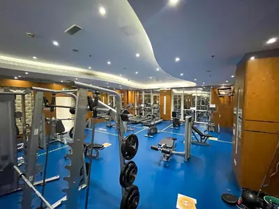 a gym with blue flooring and tread machines at Daniels 1BR Business Bay Partial Burj Khalifa View in Dubai