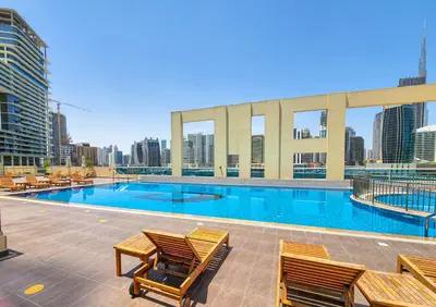 a large swimming pool on top of a building at Daniels 1BR Business Bay Partial Burj Khalifa View in Dubai