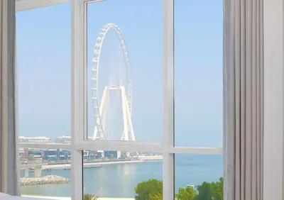 a view of the london eye from a window at Al Bateen · Ultra Luxury JBR · Private Beach and Pool in Dubai