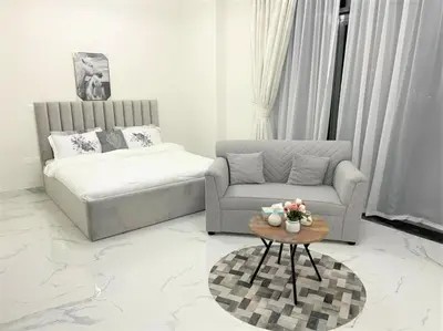 a living room with a couch and a coffee table at Amazing stay in Majan Dubai in Dubai