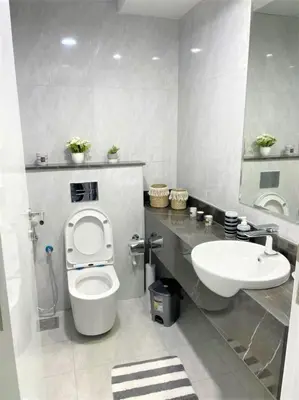 a bathroom with a toilet and a sink at Amazing stay in Majan Dubai in Dubai