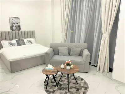 a living room with a couch and a coffee table at Amazing stay in Majan Dubai in Dubai