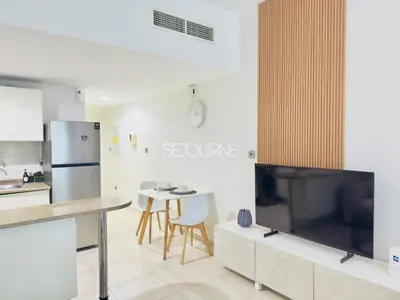 a kitchen with a large television and a table at DA86 - Well Design Studio in Dubai Arch tower in Dubai