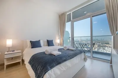 a bedroom with a large bed with a large window at Spectacular Views of Dubai Skyline in Dubai