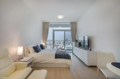 a bedroom with a large bed and a large window at Spectacular Views of Dubai Skyline in Dubai