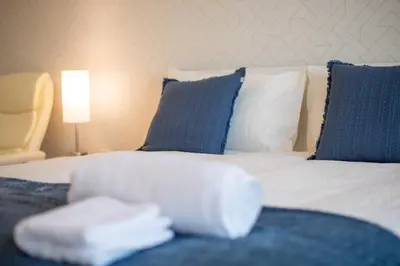 a hotel room with a bed with blue and white pillows at Spectacular Views of Dubai Skyline in Dubai