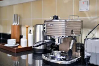 a coffee maker sitting on top of a kitchen counter at Luxury JBR Shams - Marina View - Free 5 star Beach Resorts Access! in Dubai