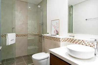 a bathroom with a sink and a toilet and a shower at Gala Guests - Marasi Drive City View Apartments in Dubai