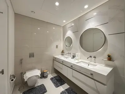 a bathroom with a sink and a toilet and a mirror at Beachfront 2BR with Spectacular Sea and Palm Views - 17AB06 in Dubai