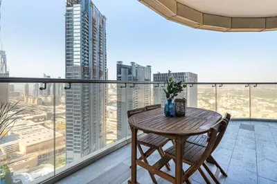 a table and chairs on a balcony with a view of a city at Frank Porter - RP Heights in Dubai