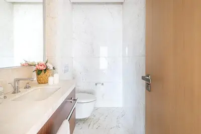 a bathroom with a sink and a toilet and a mirror at Frank Porter - RP Heights in Dubai