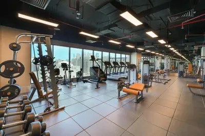 a gym with several treadmills and cardio machines at Cheval Maison - The Palm in Dubai