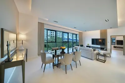 a living room with a table and chairs and a couch at Cheval Maison - The Palm in Dubai