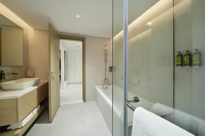 a bathroom with a sink and a shower and a tub at Cheval Maison - The Palm in Dubai