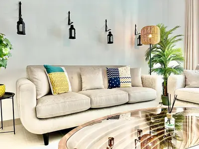 a living room with a couch and a table at Old Town- Heart of Downtown. in Dubai