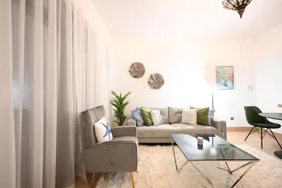 a living room with a couch and a table at Old Town- Heart of Downtown. in Dubai