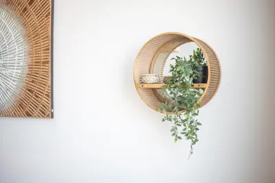 a wreath hanging on a wall with a plant at Beautiful, Stylish and Peaceful 1BD in JVC in Dubai