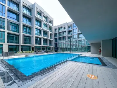 a swimming pool in the middle of a building at Beautiful, Stylish and Peaceful 1BD in JVC in Dubai