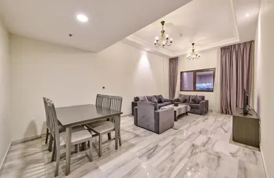 a living room with a table and a couch at Grand Stay Holiday Homes Al Jaddaf in Dubai