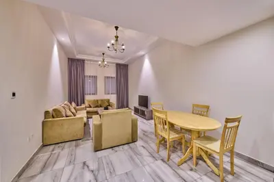 a living room with a table and a couch at Grand Stay Holiday Homes Al Jaddaf in Dubai