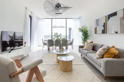 a living room with a couch and a table at Frank Porter - One Park Avenue in Dubai