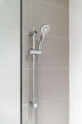 a shower with a shower head in a bathroom at Brand New 1BR in Dubai Hills Quiet and Peaceful in Dubai