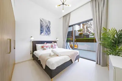 a bedroom with a bed and a large window at Brand New 1BR in Dubai Hills Quiet and Peaceful in Dubai