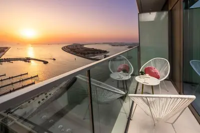 a balcony with chairs and a view of the ocean at prime retreats - beach vista Emaar in Dubai