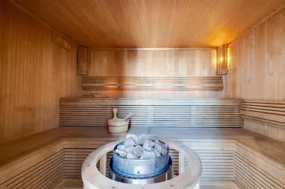 a sauna with a tub in the middle of the room at Luxury Apt - Rooftop Pool - City View in Dubai